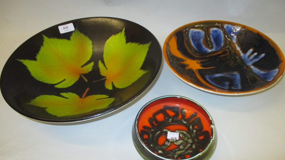 Large Poole Pottery fruit bowl decorated with leaves together with two similar smaller bowls