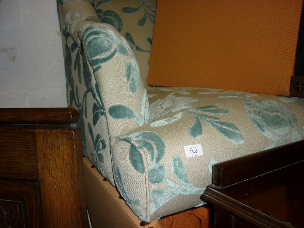 Modern floral upholstered two seat sofa on turned front supports