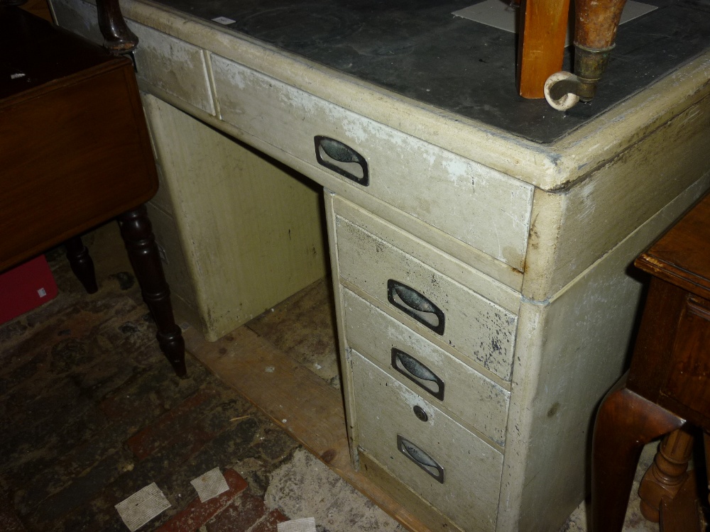 1950`s Cream painted pedestal desk with an arrangement of nine drawers on plinth bases