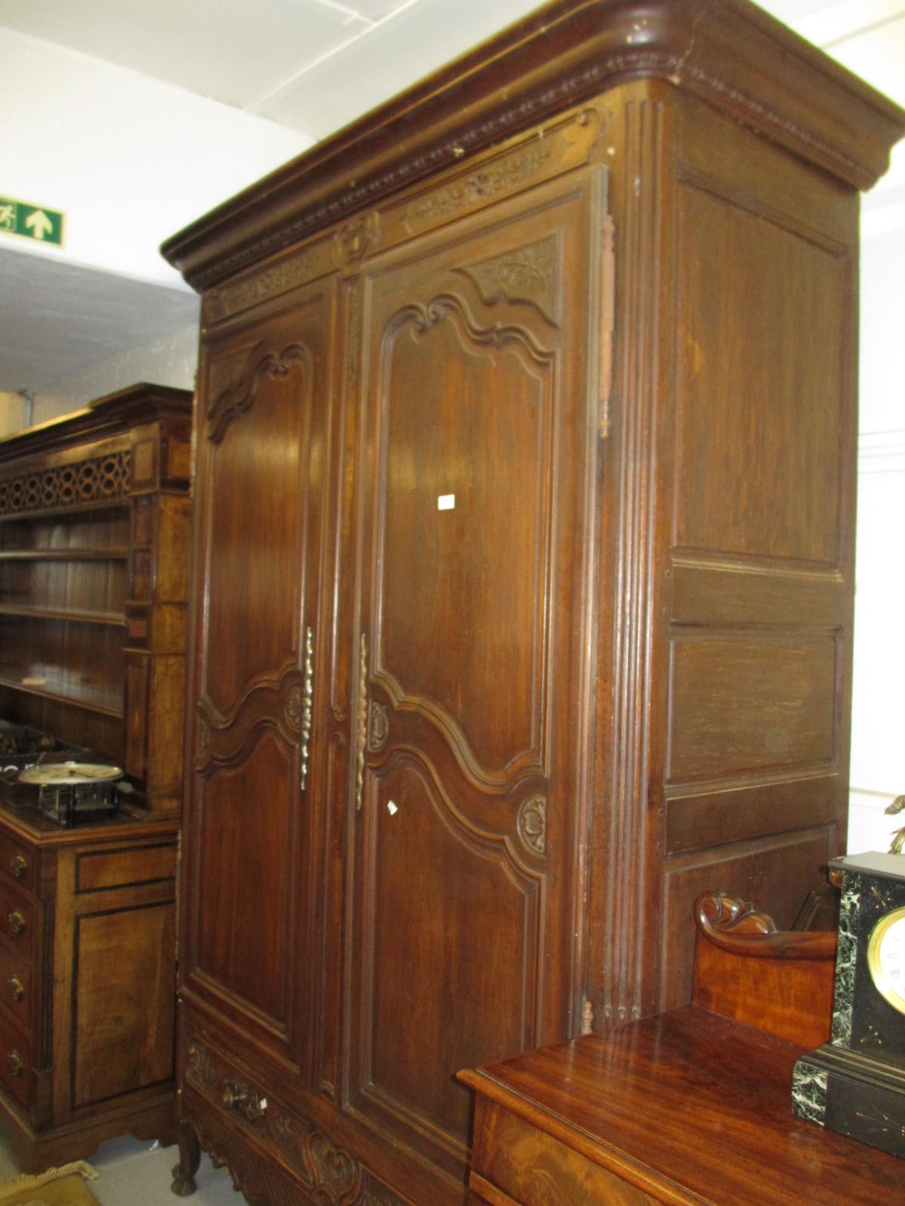 18th Century French fruitwood armoire with typical panel doors on cabriole front supports with pad