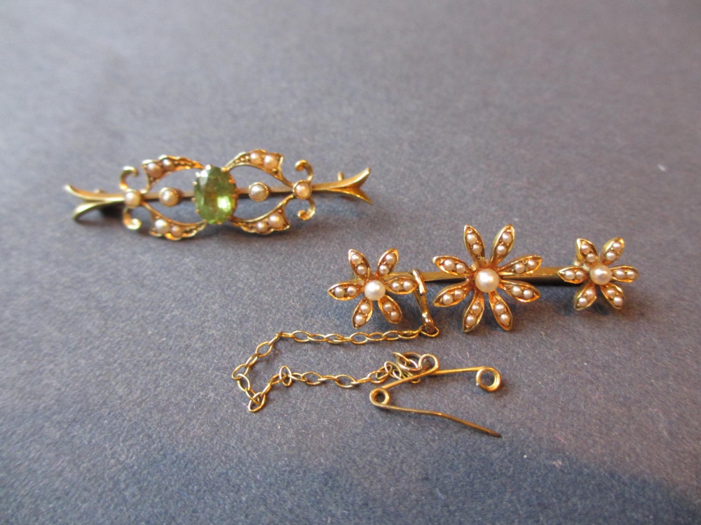 Edwardian split pearl and peridot set bar brooch, together with another similar in the form of