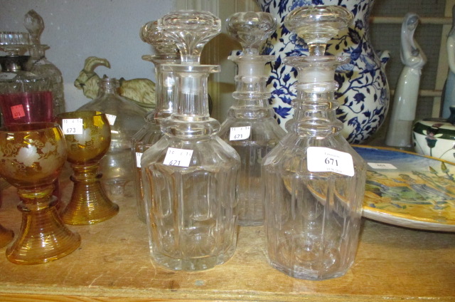 Group of four small late 18th / early 19th Century cut glass decanters with stoppers and a glass fly