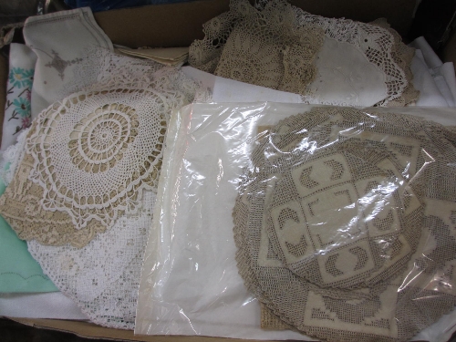 Two trays containing a quantity of various table linen, mats etc.