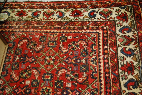 Hamadan carpet having all-over floral design with multiple borders on a wine ground, 85ins x 132ins