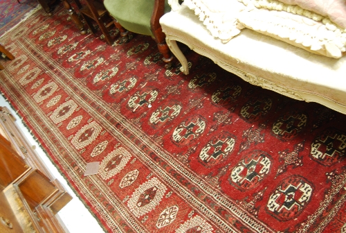 Tekke carpet with six rows of gols on a wine ground with multiple borders (some wear)