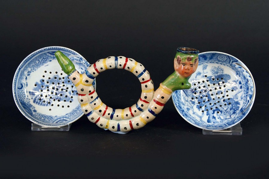 A PIPE with a bacchus mask bowl, 5 1/2ins. (14cms.) wide overall, together with two Spode blue and