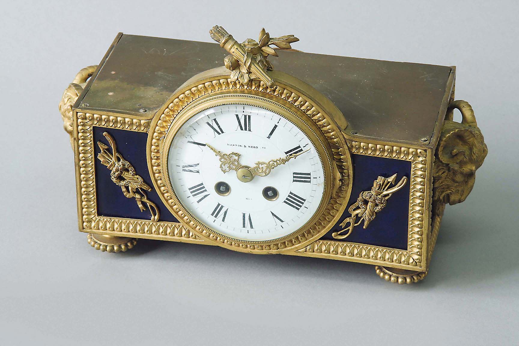 AN ORMOLU MANTEL CLOCK of Louis XVI inspiration, dial white enamel, signed Mappin & Webb Ltd.,