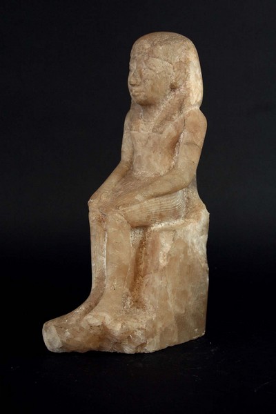 AN EGYPTIAN ALABASTER CARVING of a seated figure, 11 1/2ins. (29cms.) highCondition reports are
