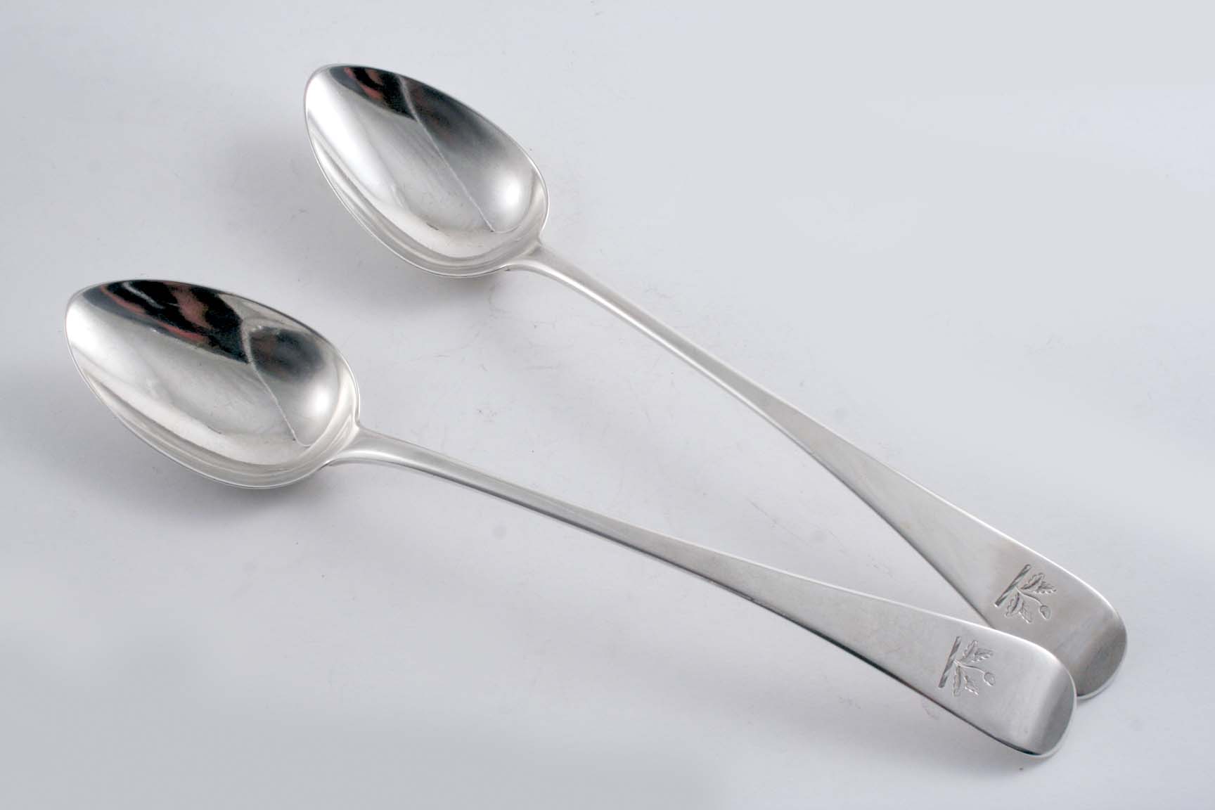 A PAIR OF GEORGE III OLD ENGLISH PATTERN BASTING SPOONS crested, by Thomas Wallis & Jonathan