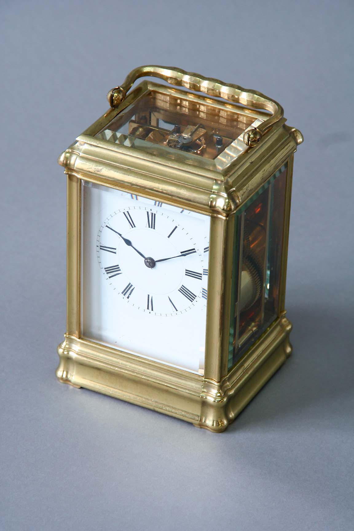 AN ORMOLU CARRIAGE CLOCK dial white enamel, movement with lever escapement, striking on a gong, case