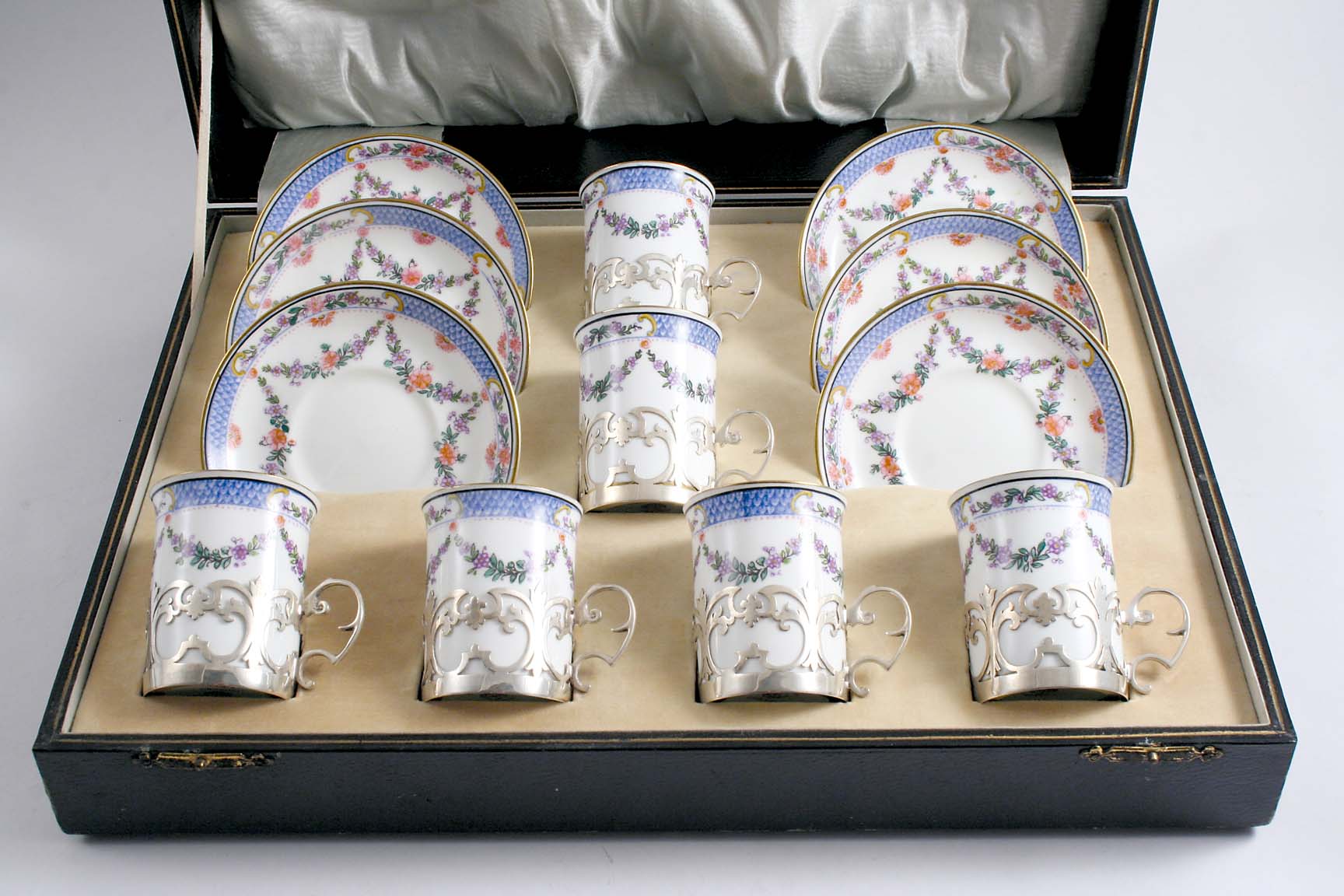 A MODERN CASED SET OF SIX MOUNTED CRESCENT PORCELAIN DEMI-TASSE COFFEE CUPS & SAUCERS, the mounts