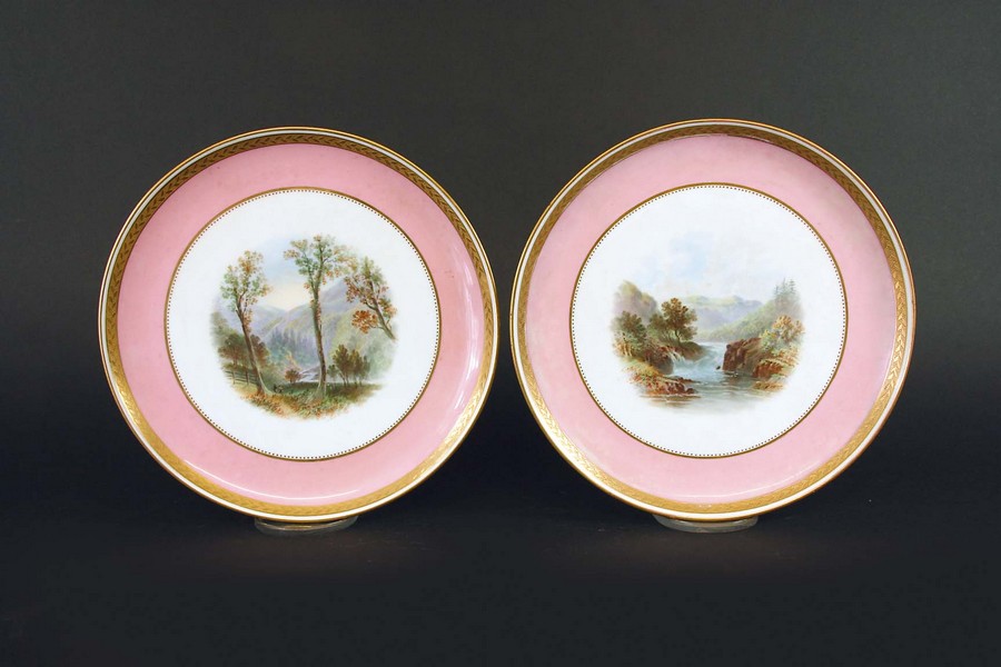 A PAIR OF MINTON COMPORTS each painted with a named view, within a gilt enriched pink border, Glen