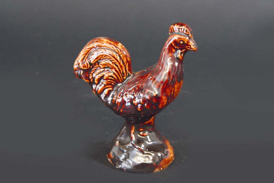 A TREACLE GLAZED FIGURE of a cockerel, 4ins. (10cms.) highCondition reports are available via the ‘