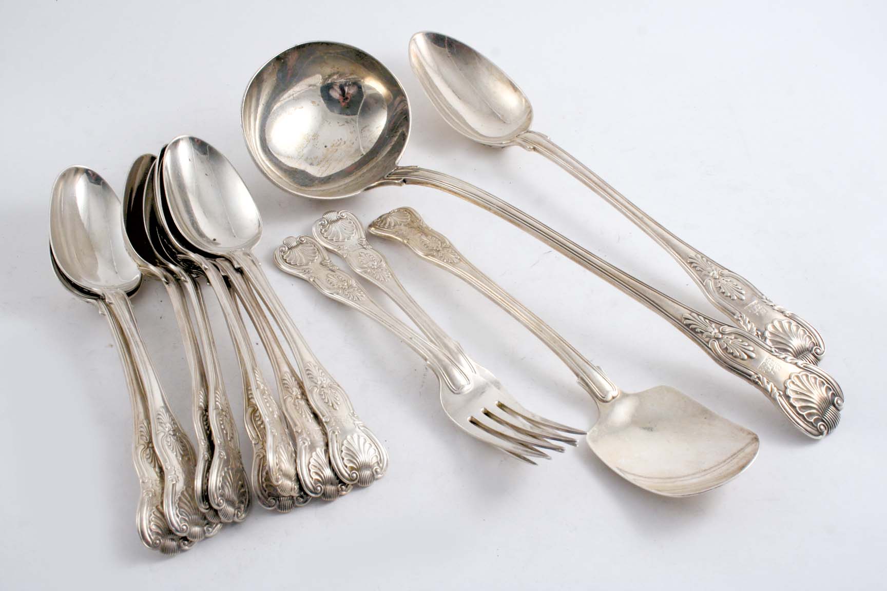 KING`S PATTERN: A part William IV set (with diamond shell heel), including eight table spoons, two
