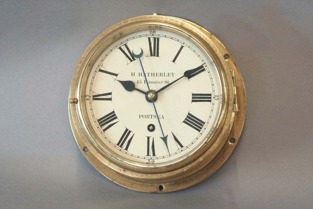 A BRASS SHIPS BULK HEAD TIMEPIECE  dial cream painted, signed H. Hatherley, 45 Hanover St., Portsea,
