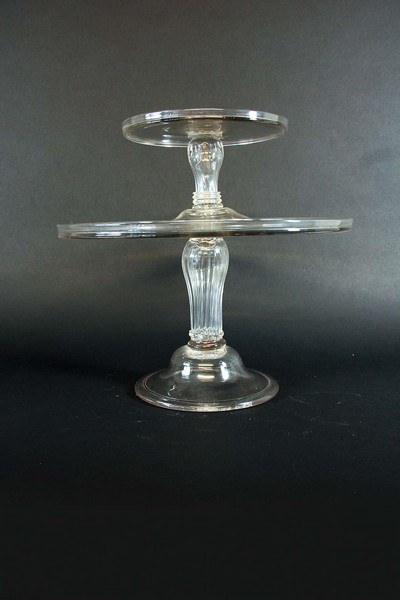 TWO TAZZAE each with a slight upstanding rim, on a fluted baluster stem, 7 1/4ins. (18.5cms.) and 12