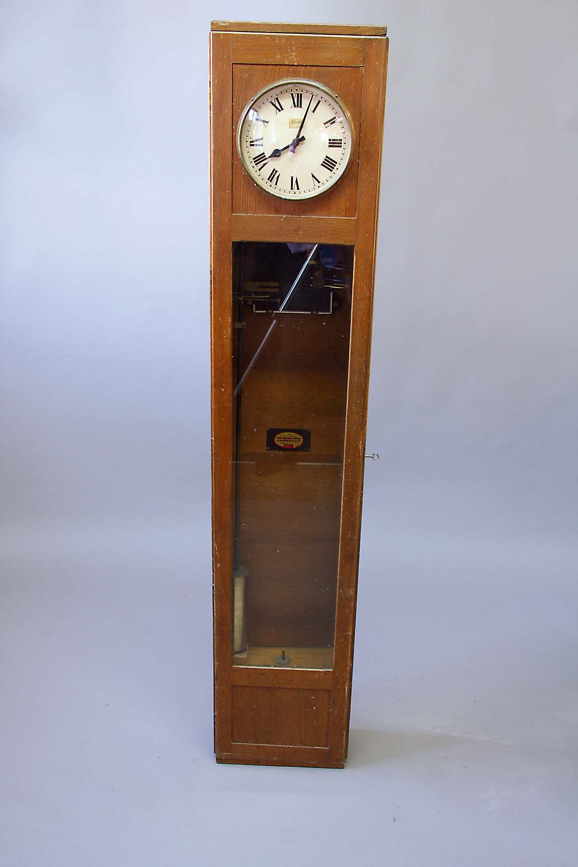 AN OAK ELECTRIC MASTER CLOCK dial cream, signed Heap Installations, 63ins.(160cms.) high x 12 1/