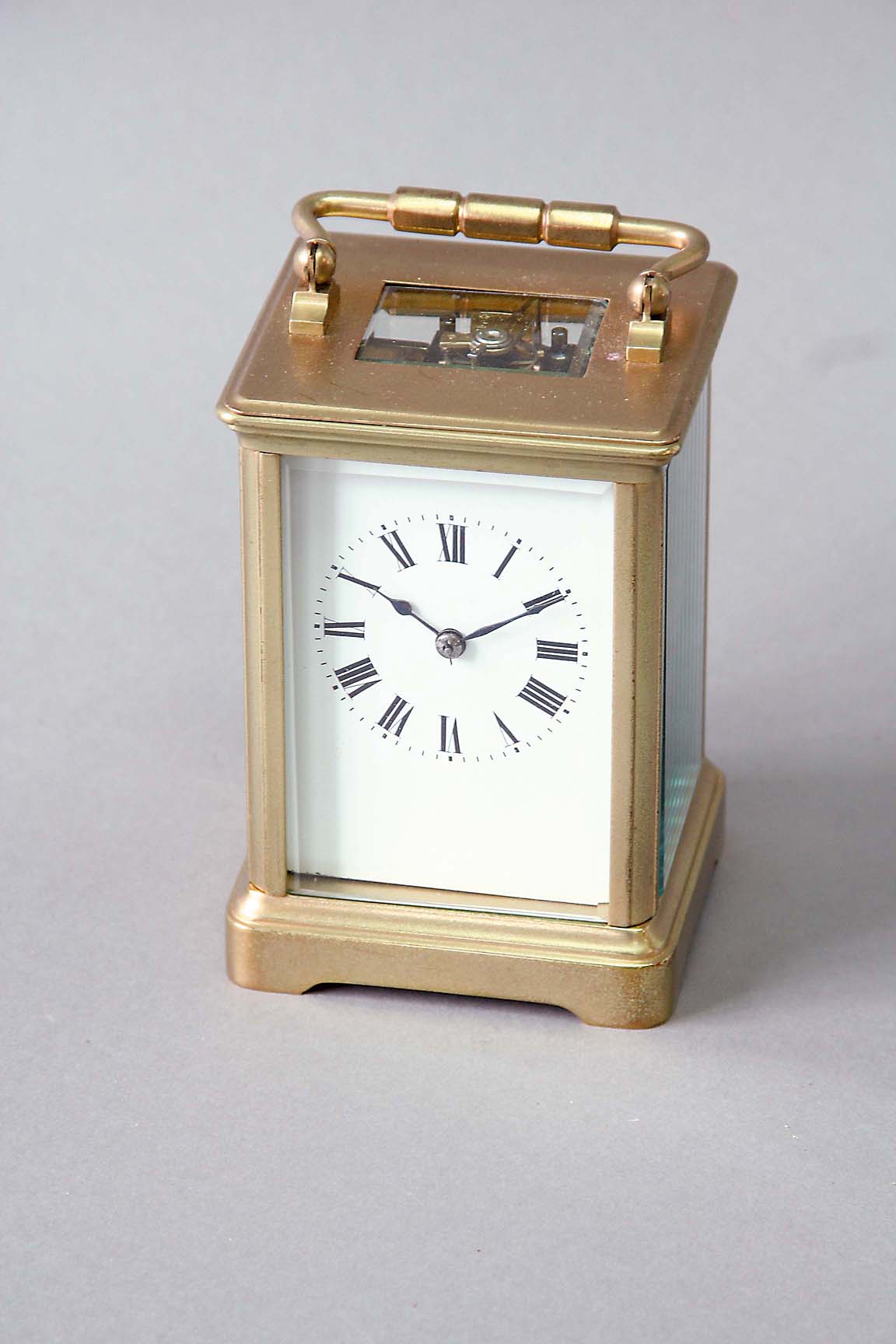 A CARRIAGE CLOCK dial white enamel, movement cylinder escapement striking on a gong, 5ins. (