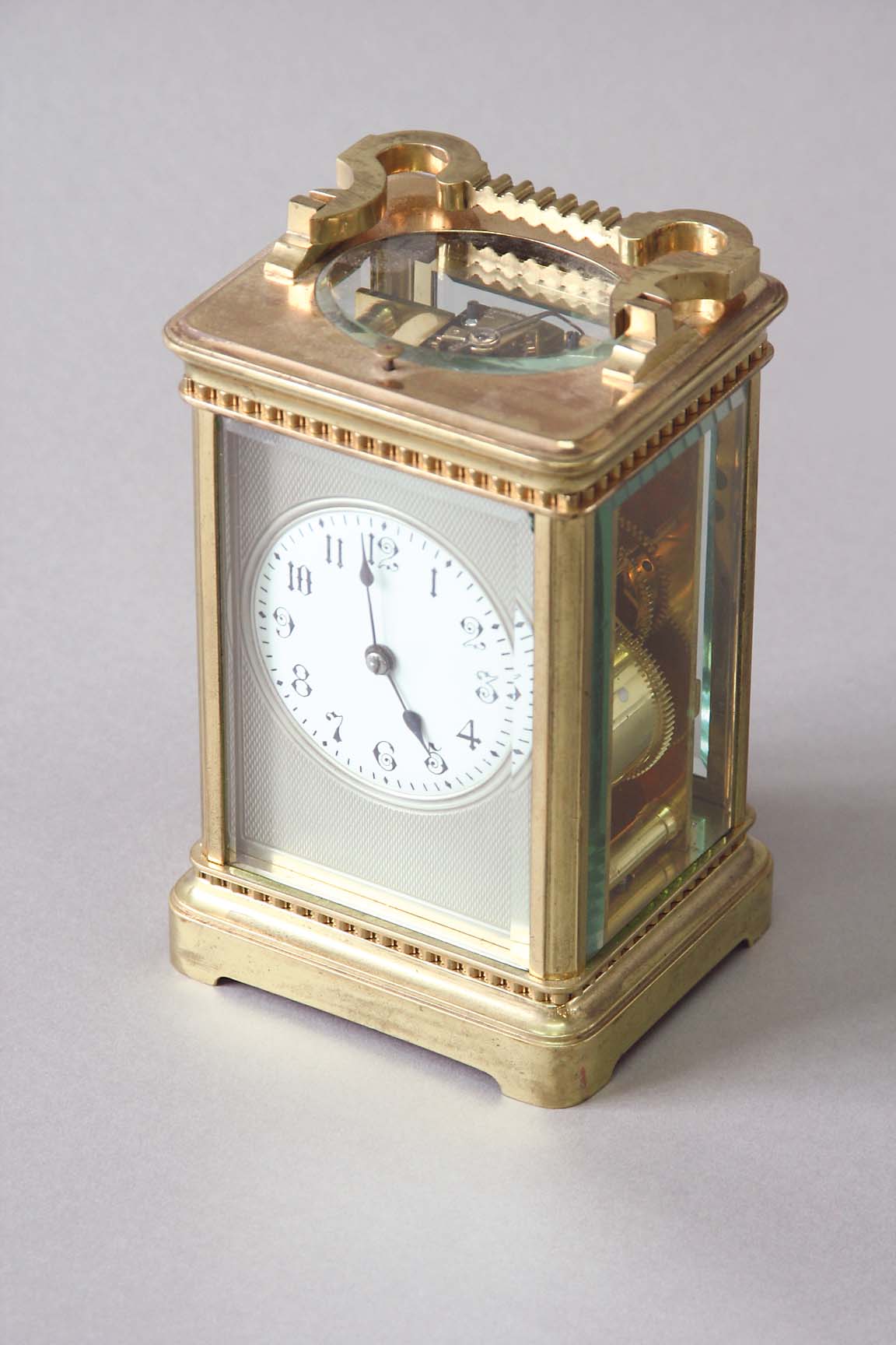 A CARRIAGE CLOCK dial white enamel set on a silvered engine turned ground, movement repeating, lever