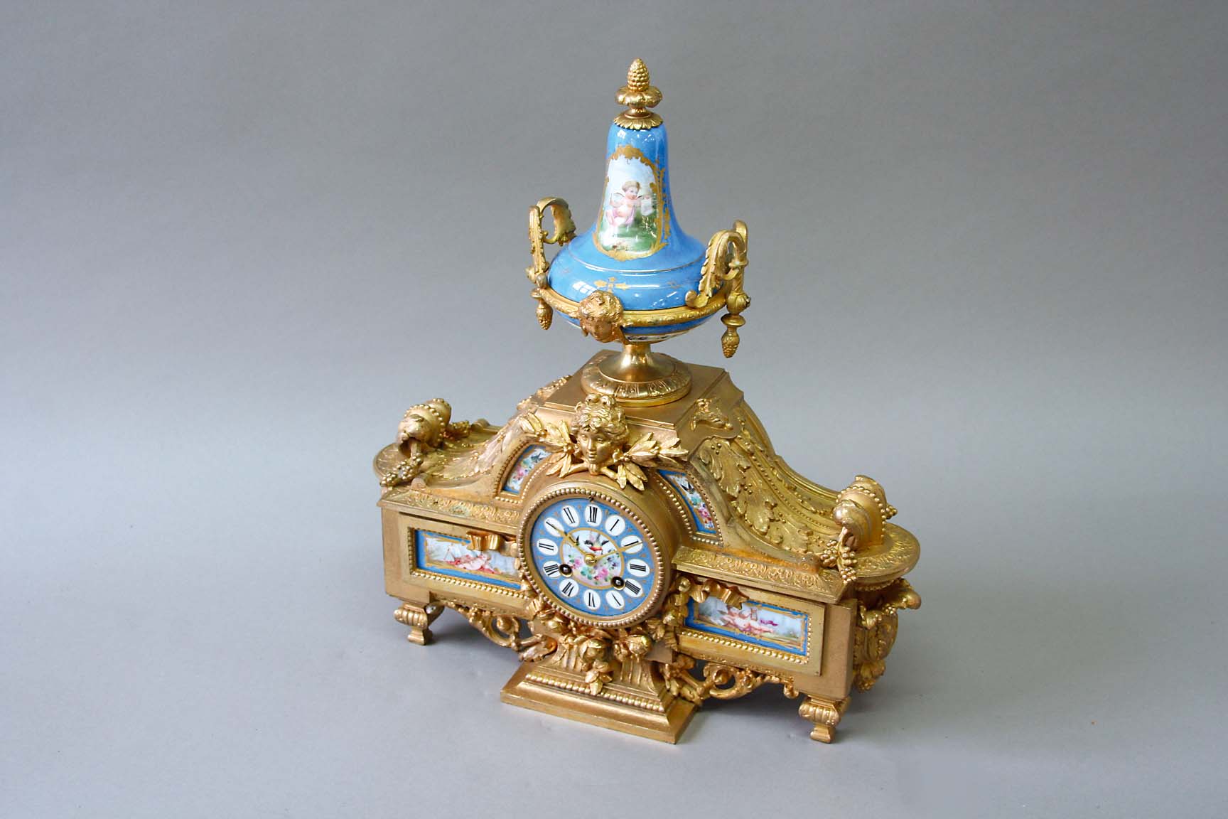 A GILT SPELTER AND TURQUOISE "SEVRES" MANTEL CLOCK dial painted with a central floral and bird