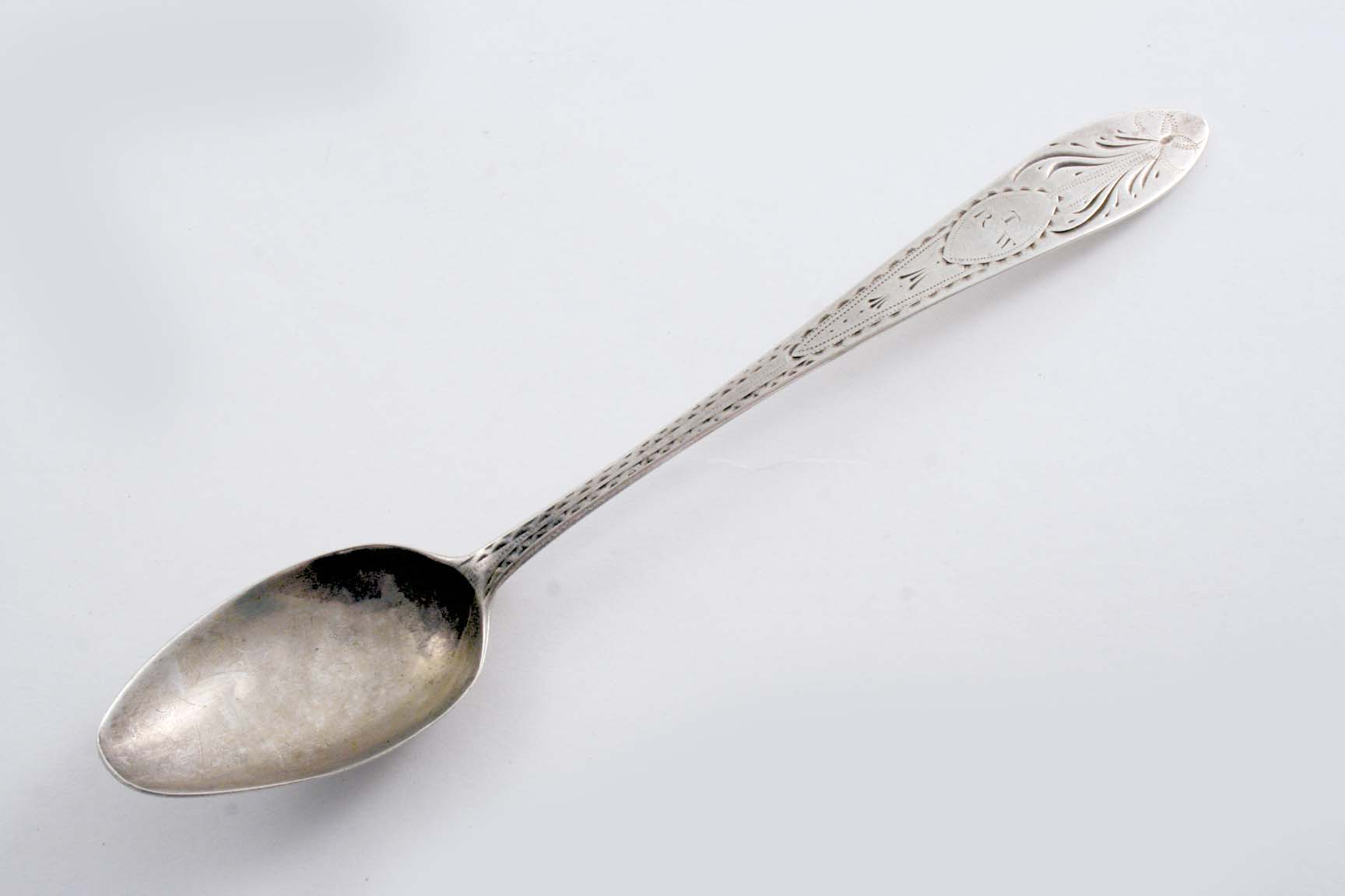 IRISH PROVINCIAL: A George III bright-cut dessert spoon, initialled "T" over "RW", by William