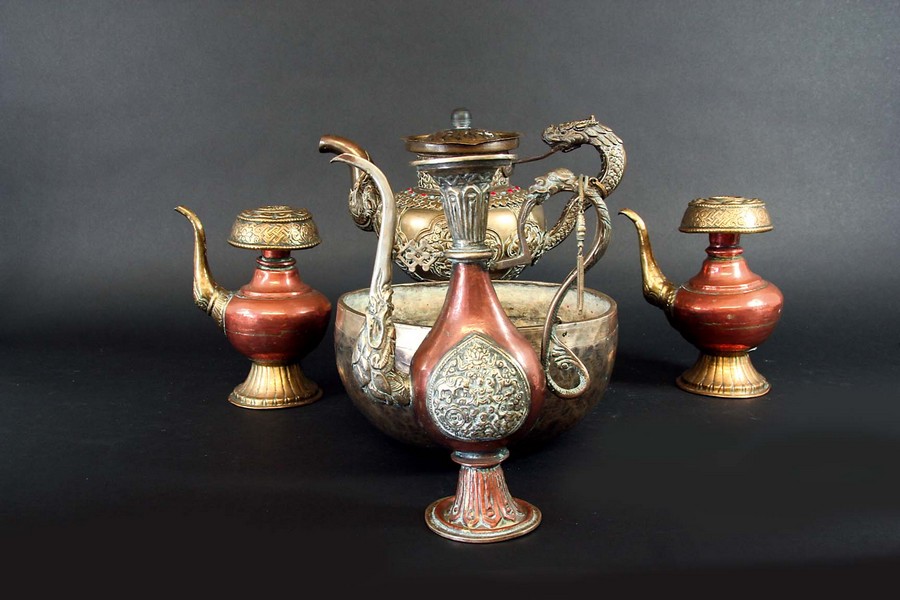 A COLLECTION OF TIBETAN BRASS AND BRASS AND COPPER TEA AND WATER CEREMONY VESSELS teapot 7 1/2ins.(