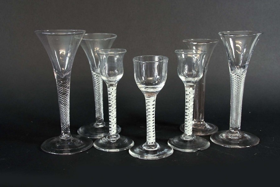 A NEAR PAIR OF OPAQUE TWIST CORDIALS each with a tulip bowl and spiral gauze with solid tape,