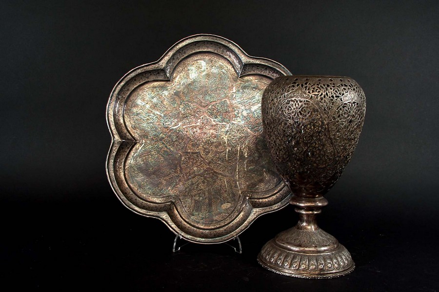 A PERSIAN SILVER COLOURED METAL VASE the ovoid body delicately pierced with foliate scrolls, 10 1/