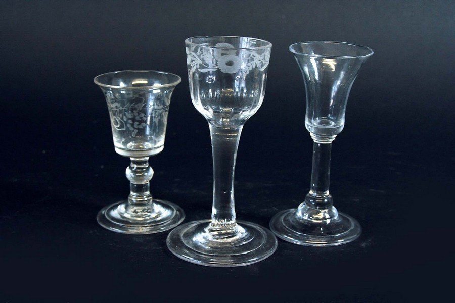 A CORDIAL engraved with a band of flowering foliage above moulded fluting, turnover foot, 5ins. (