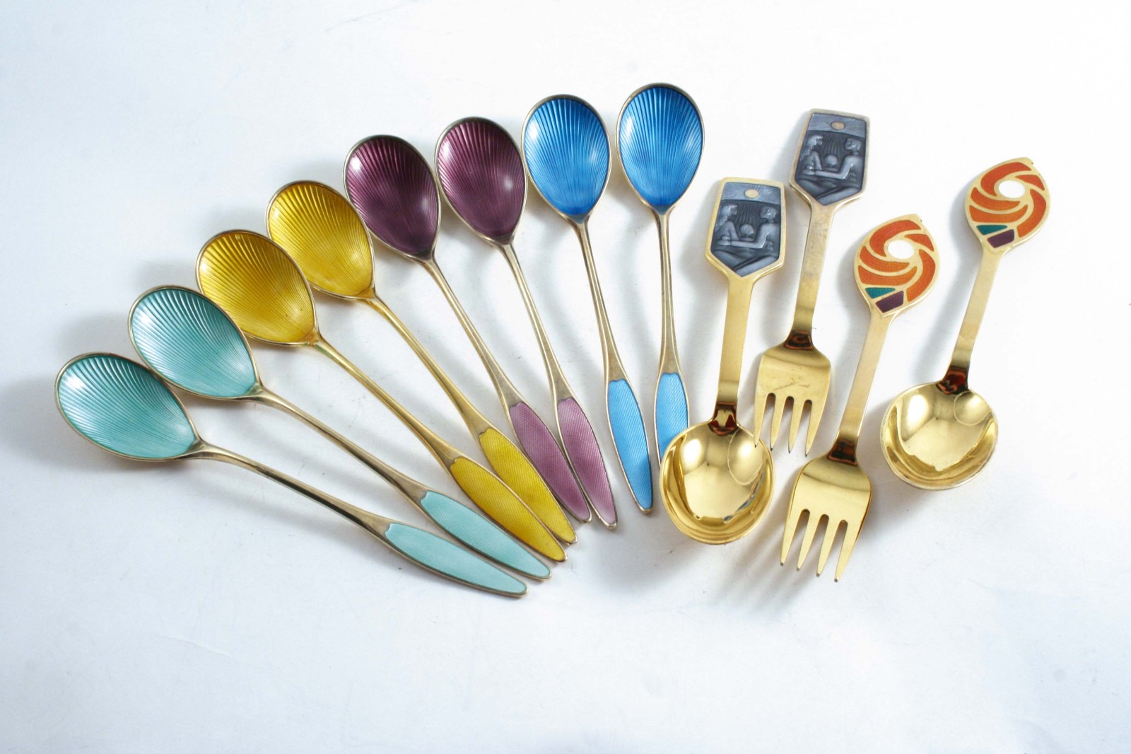 DANISH SILVERGILT & ENAMELLED FLATWARE INCLUDING:- Four pairs of spoons with coloured bowls &