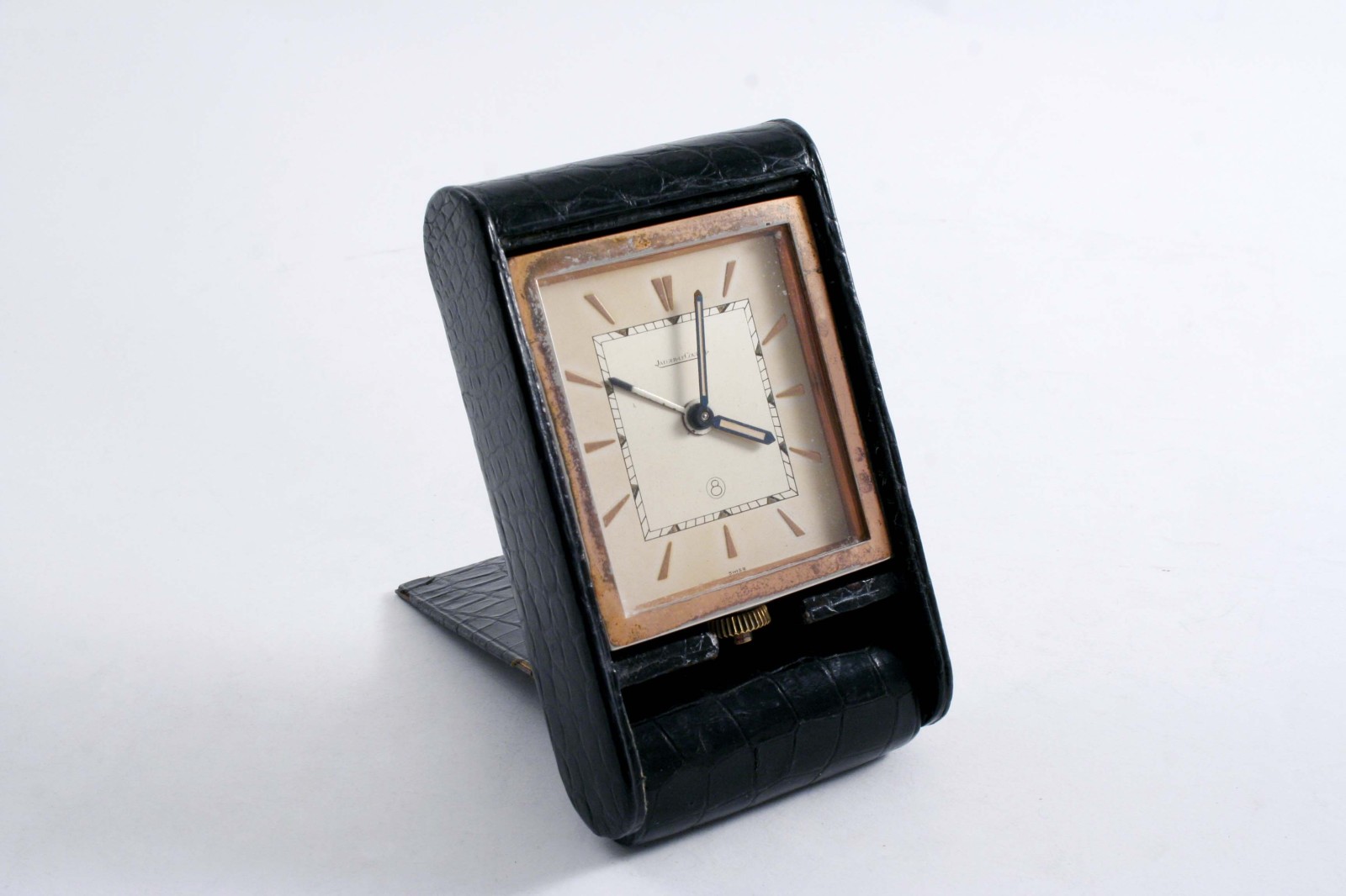 A 20TH CENTURY SWISS GILT METAL & LEATHER CLAD TRAVELLING ALARM TIMEPIECE, unfolding for use, by