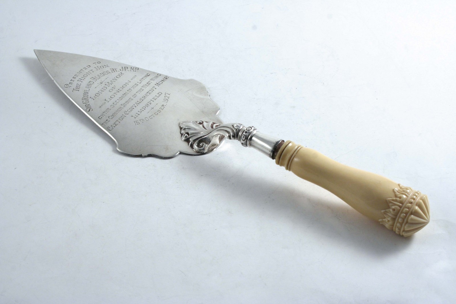 A MODERN PRESENTATION TROWEL with a carved ivory handle, inscribed "Presented to the Right Hon.