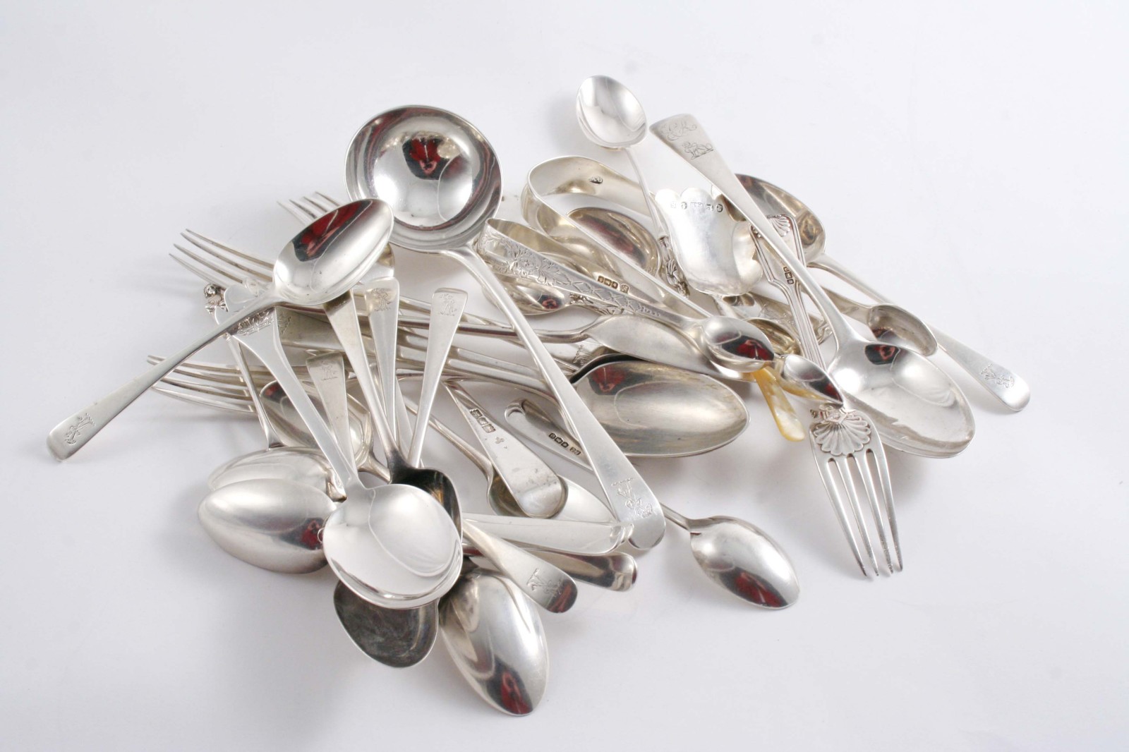 MIXED FLATWARE: An Old English pattern sauce ladle, twelve tea spoons, four dessert forks and