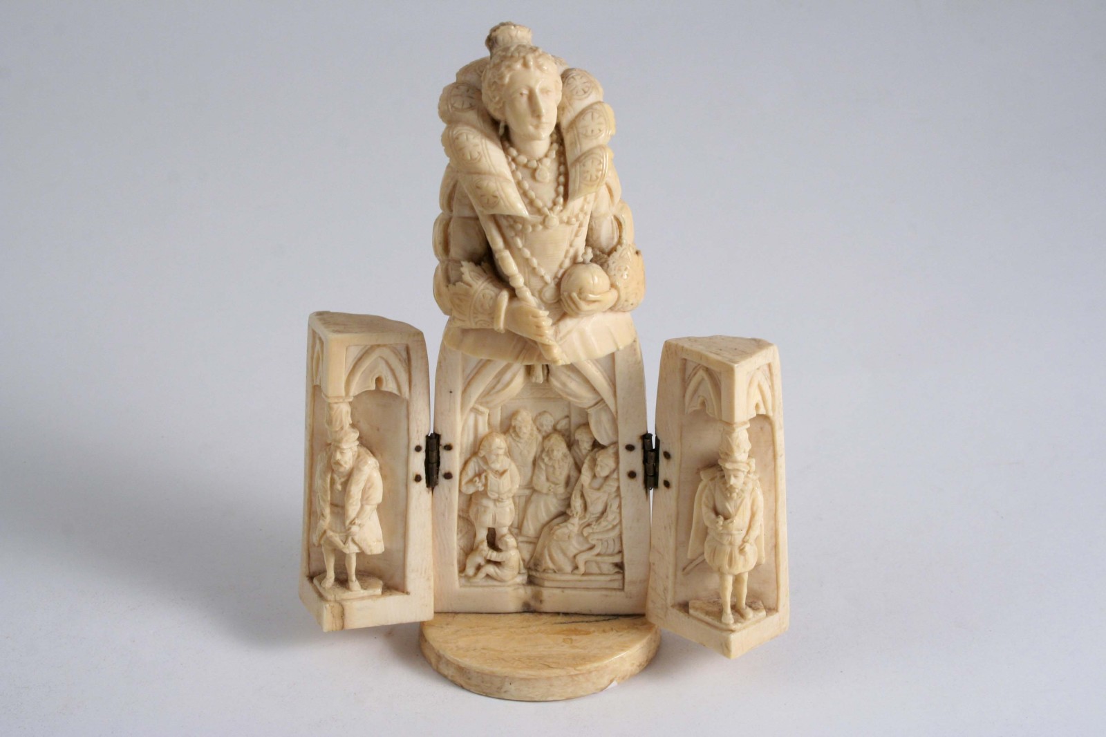 A CARVED IVORY FIGURE probably Queen Elizabeth I, the lower part opening to reveal an interior scene