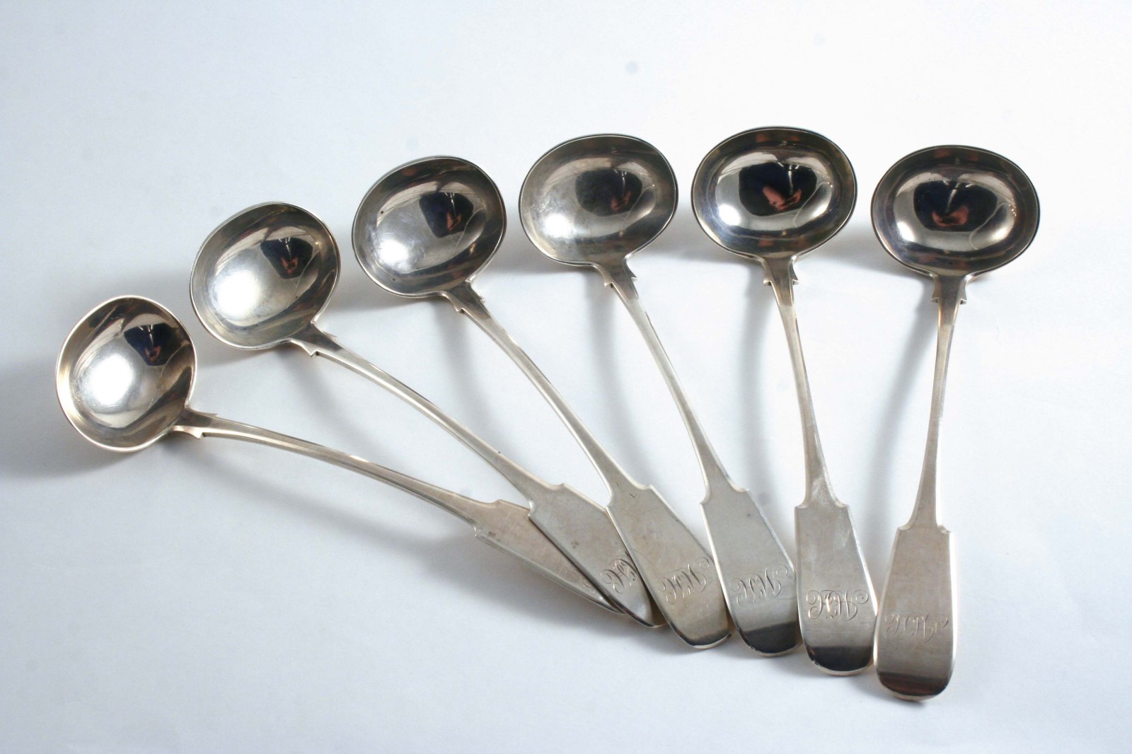 A SET OF SIX GEORGE III / IV SCOTTISH PROVINCIAL TODDY LADLES Fiddle pattern, initialled "McH", by