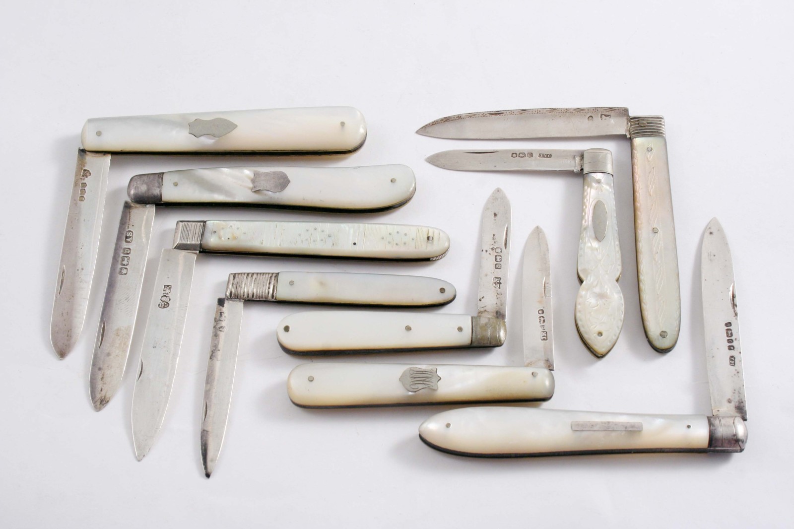 NINE VARIOUS MOTHER OF PEARL MOUNTED, FOLDING FRUIT KNIVES mixed makers & dates, George III -