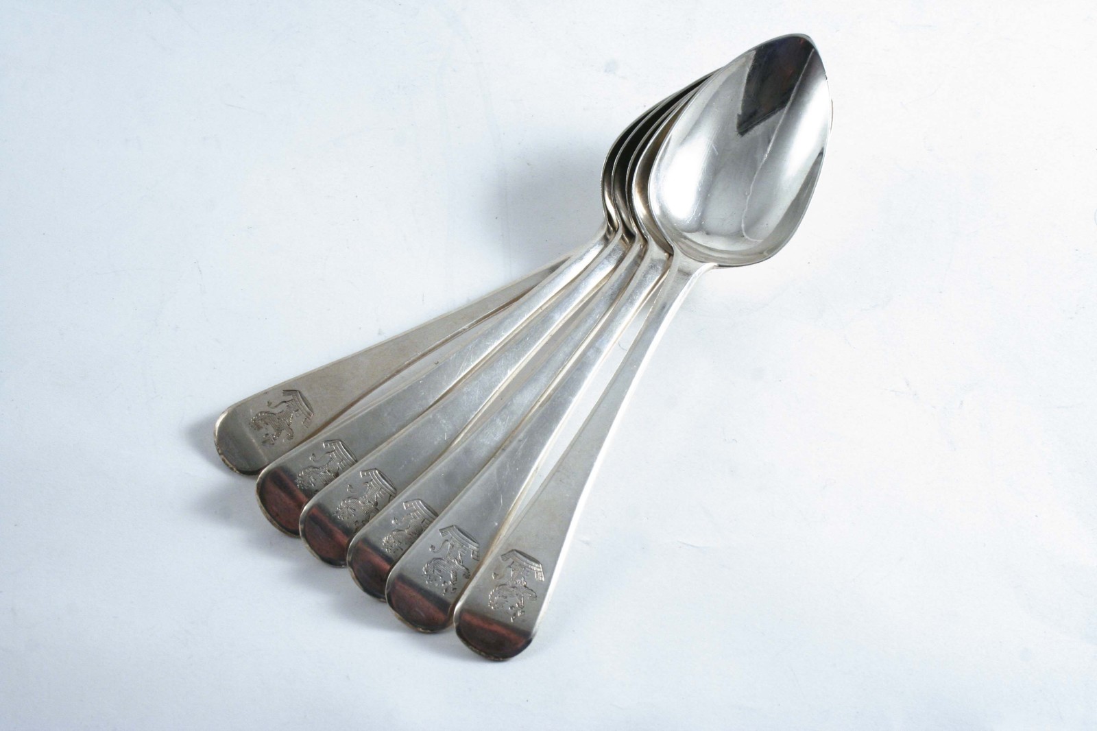 A SET OF SIX GEORGE III OLD ENGLISH PATTERN DESSERT SPOONS crested, by Stephen Adams, London