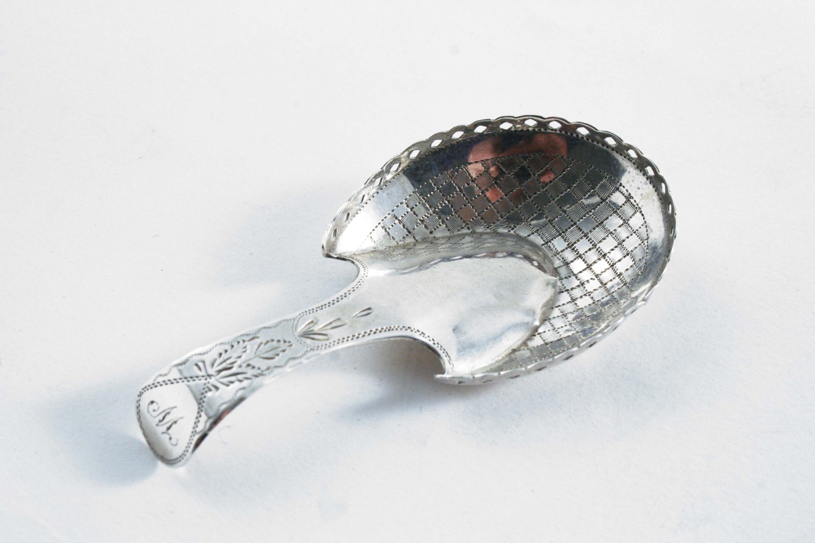 A GEORGE III "PASTERN HOOF" CADDY SPOON with engraving & a pierced gallery, initialled "W", by Cocks