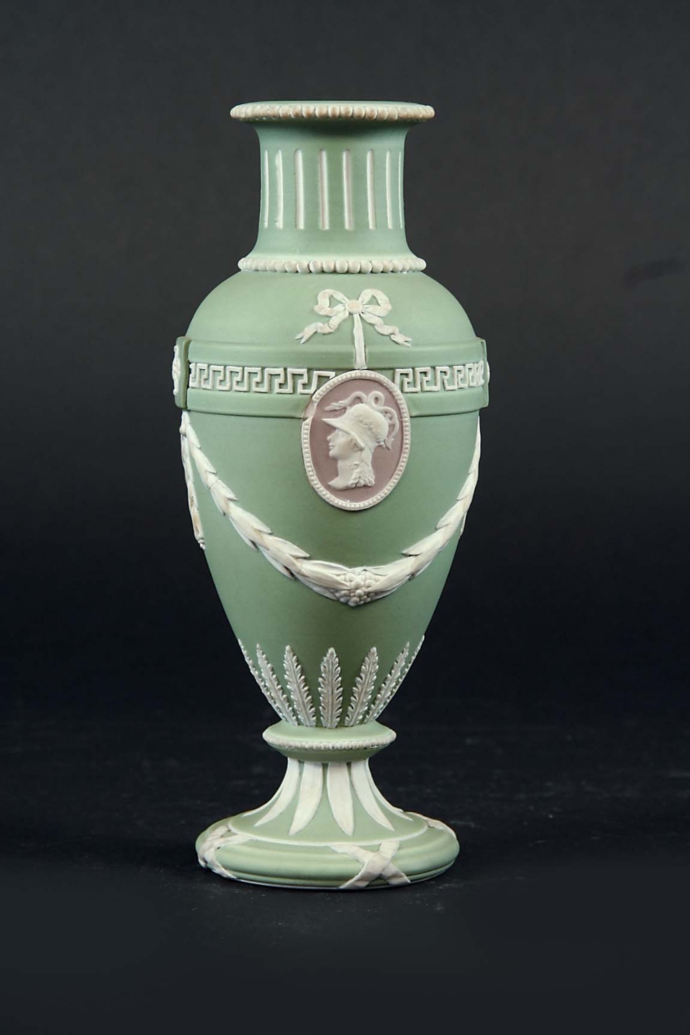A WEDGWOOD THREE COLOUR JASPER URN the shoulders with ribbons suspending portrait medallions,