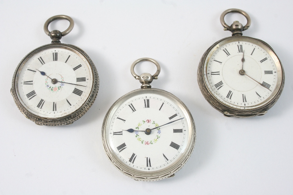 A SILVER OPEN FACED POCKET WATCH the white enamel dial with Roman numerals and polychrome enamel