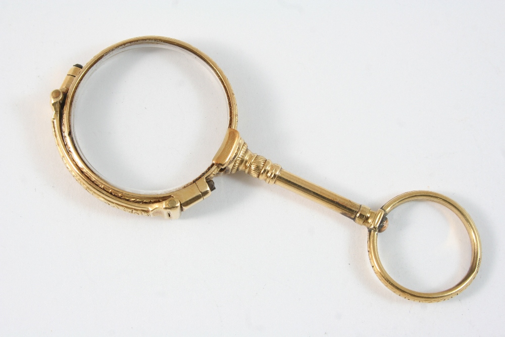 A PAIR OF GOLD LORGNETTES engraved with foliate decoration, 8.5cm. long, 27 grams. Condition reports