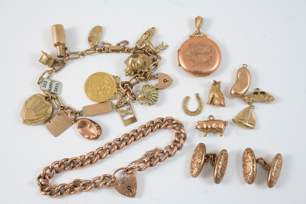 A 9CT. GOLD CHARM BRACELET set with various charms, including a gold half sovereign mounted as a