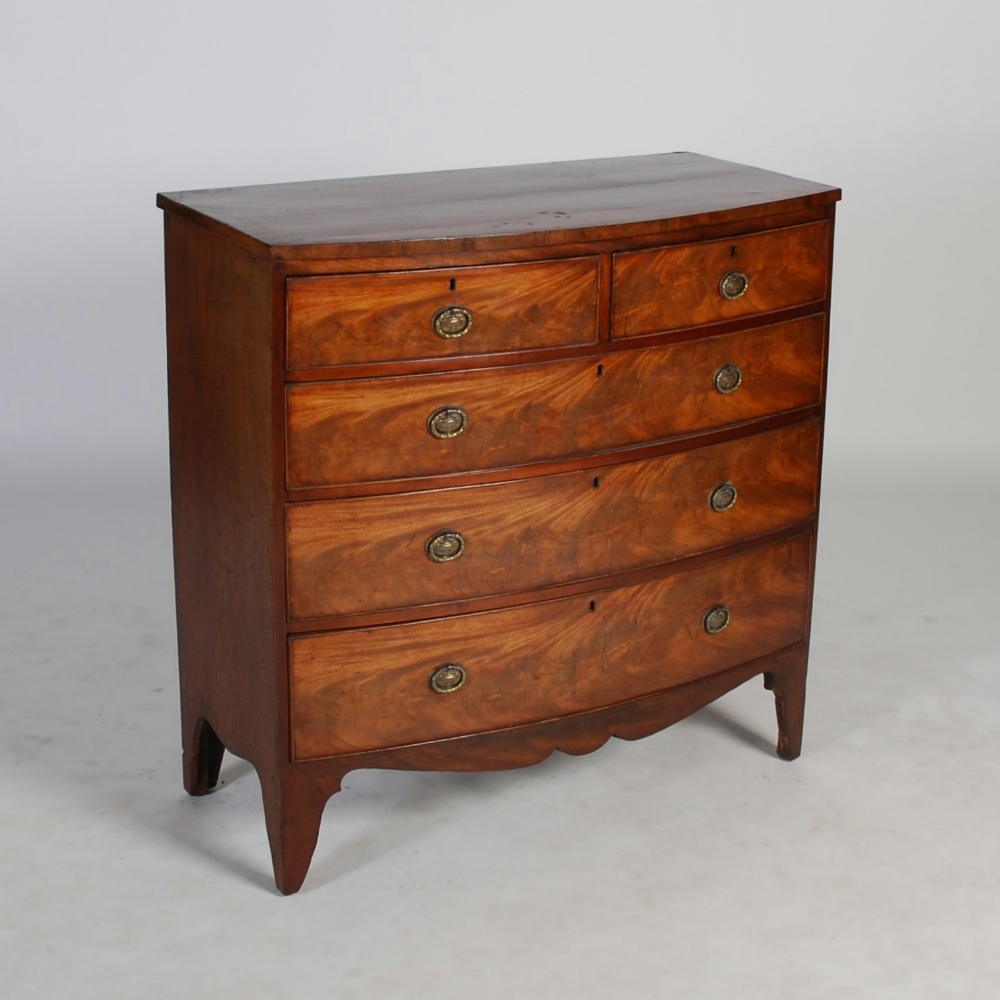 A George III mahogany bow front chest, the shaped top above two short and three long graduated