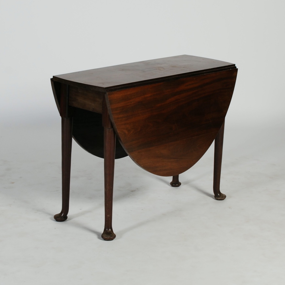 A George III laburnam drop leaf table, the oval top with twin drop leaves, raised on tapered