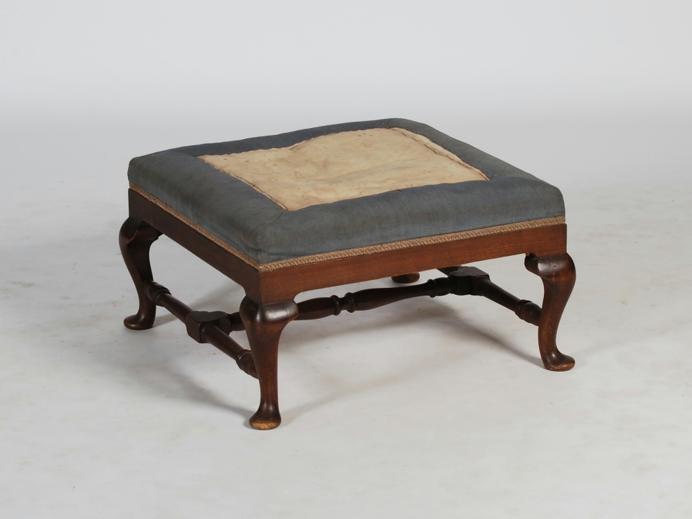 A 19th century mahogany stool, the square upholstered top above a plain frieze, raised on four short