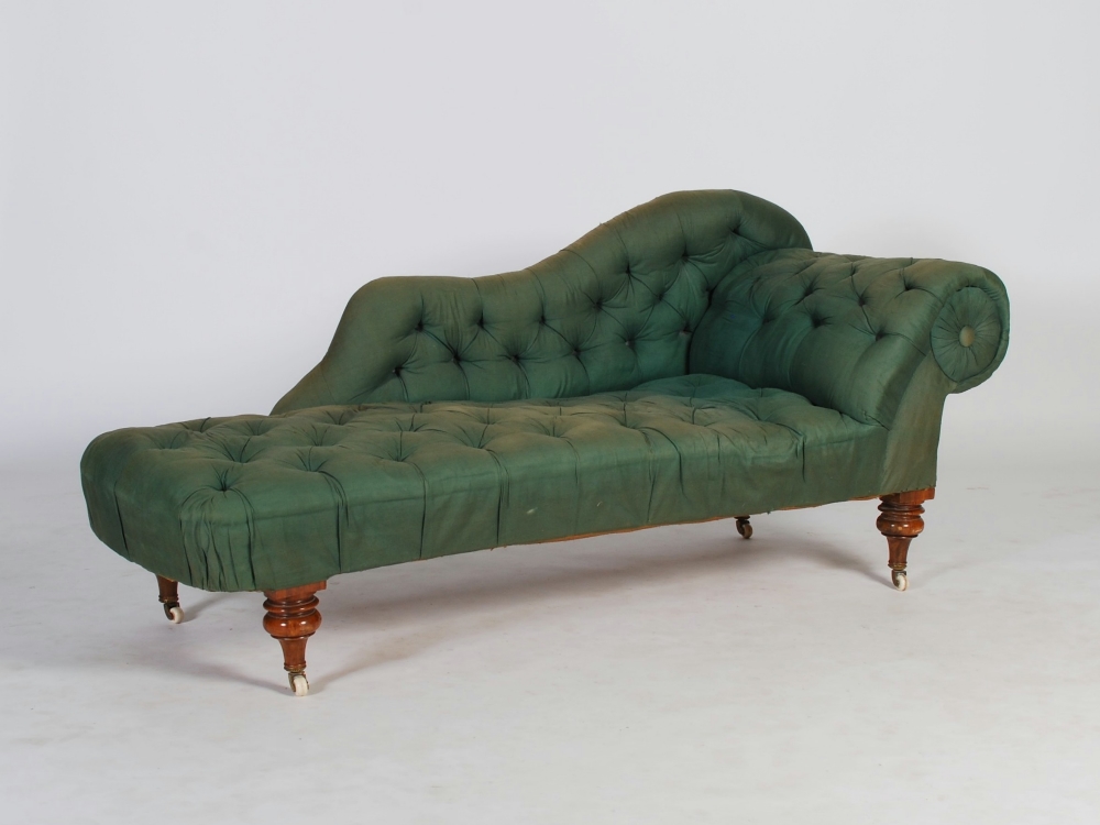 A Victorian walnut chaise longue, the green button down upholstered back, arm and seat raised on