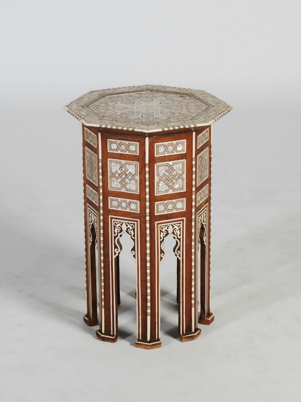 A late 19th/ early 20th century mother of pearl, bone and parquetry inlaid Eastern octagonal