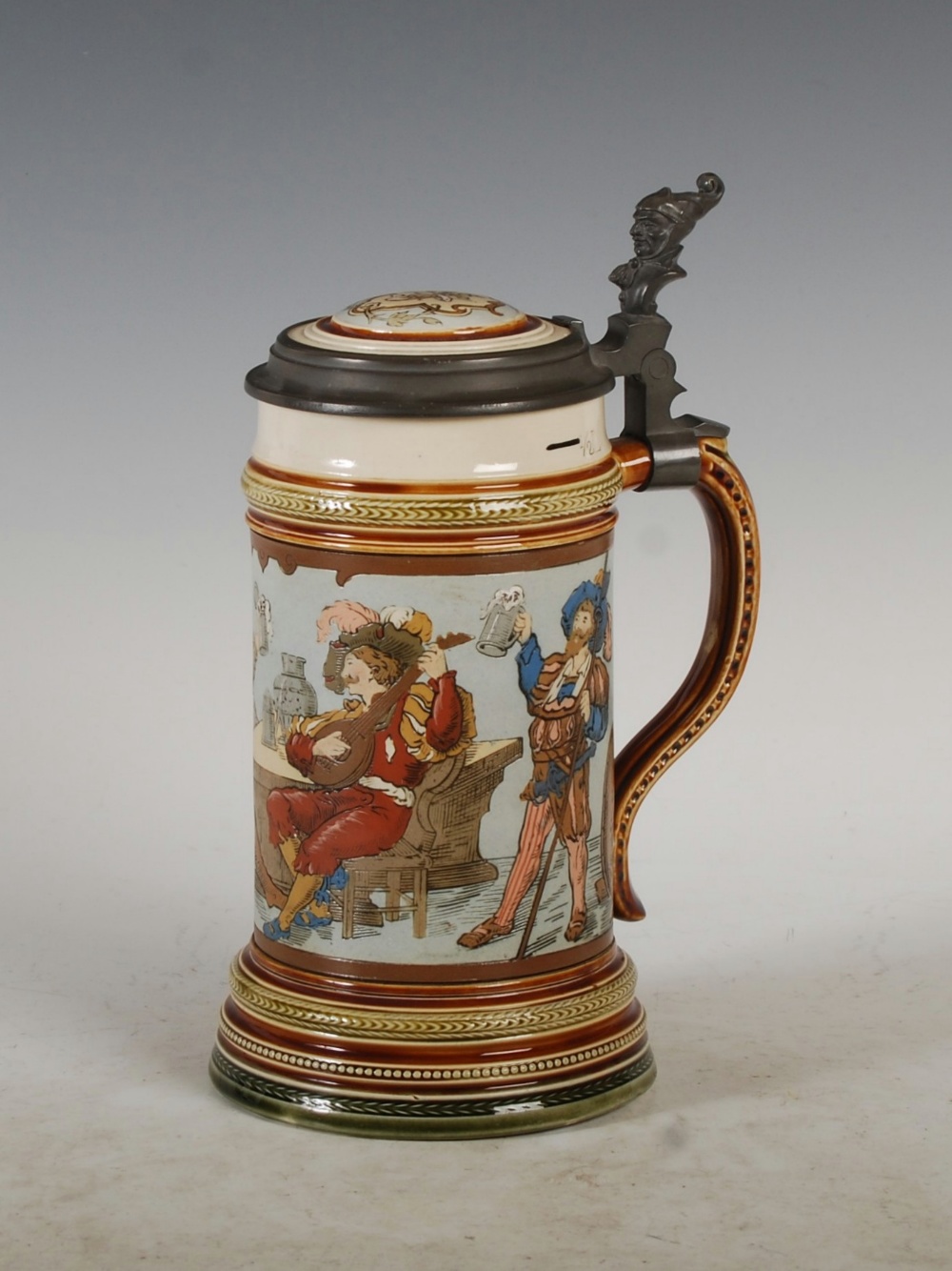 A Mettlach pewter mounted stoneware stein `GES- GESCH`, with incised decoration of figures in a