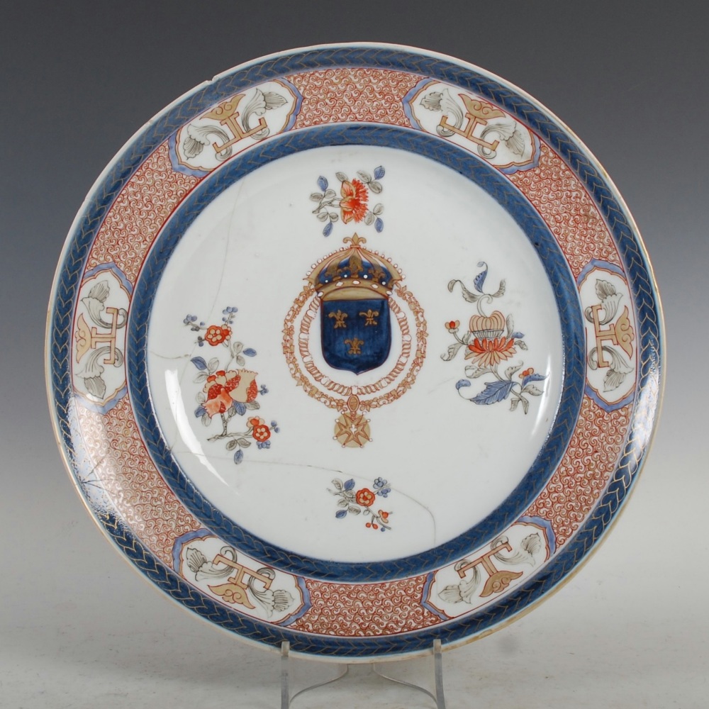 A Samson Imari Armorial charger, decorated with faux Armorial and scattered foliate sprays, within