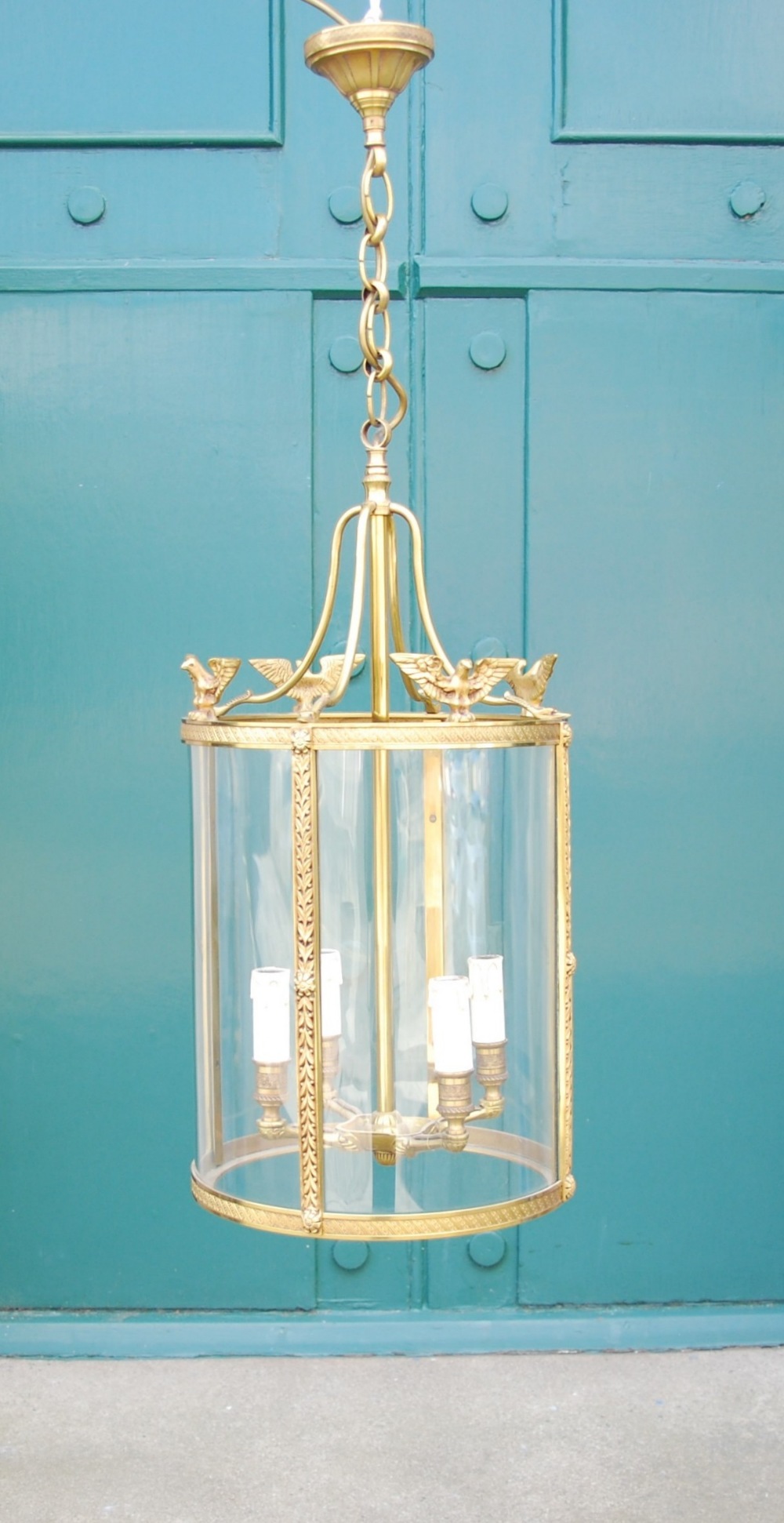 A Regency style brass hanging four light hall lantern, with swan head, eagle and foliate details,